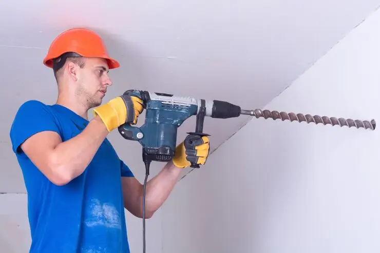 young-handyman-duty-with-electric-drill-foundation-repair-pros